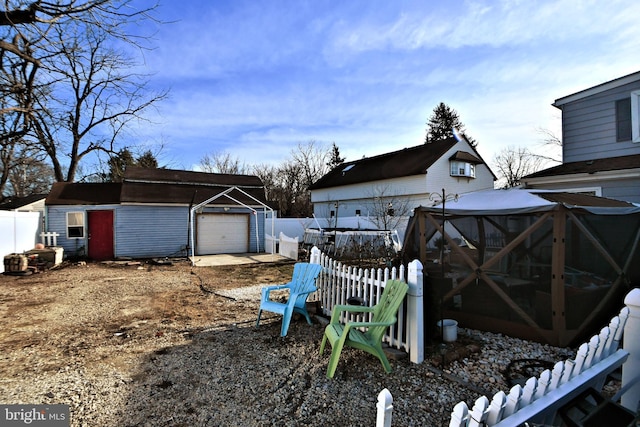 view of yard featuring a garage and an outbuilding