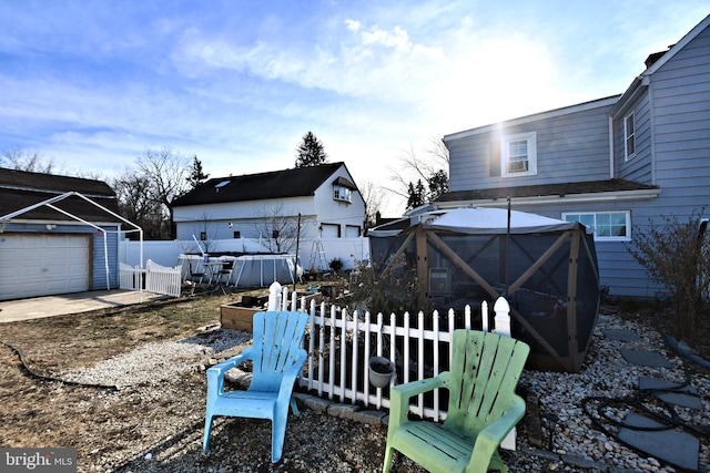 view of yard featuring a gazebo, a garage, and an outdoor structure