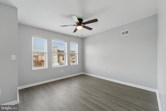 empty room featuring dark wood-type flooring and ceiling fan