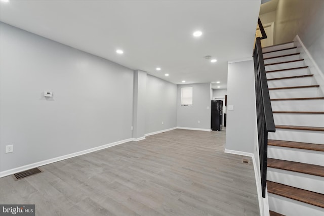 basement featuring light hardwood / wood-style flooring