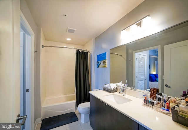 full bathroom featuring tile patterned floors, vanity, toilet, and shower / bath combo with shower curtain