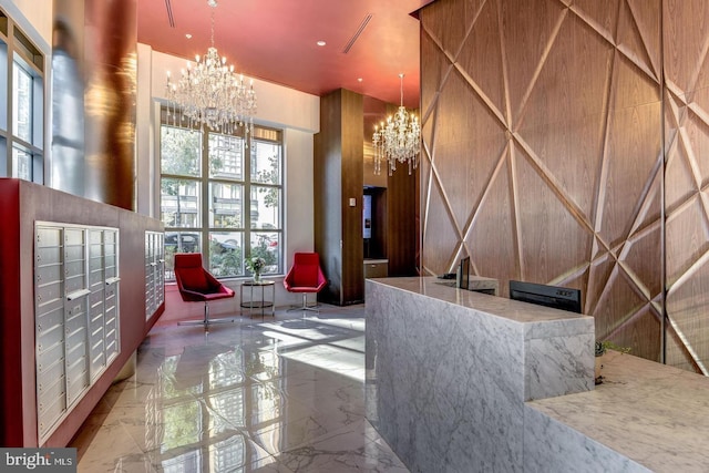 reception featuring a mail area and a notable chandelier