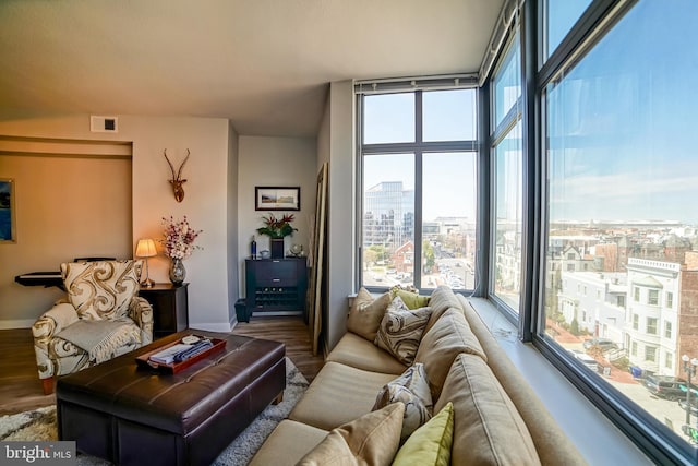 living room featuring floor to ceiling windows and hardwood / wood-style floors