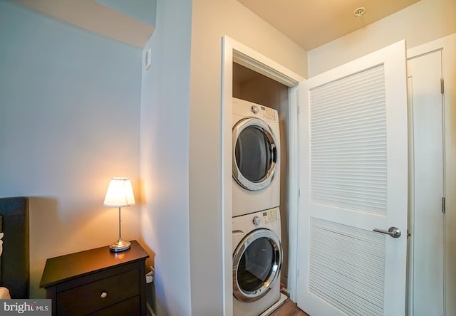 clothes washing area featuring stacked washer / dryer