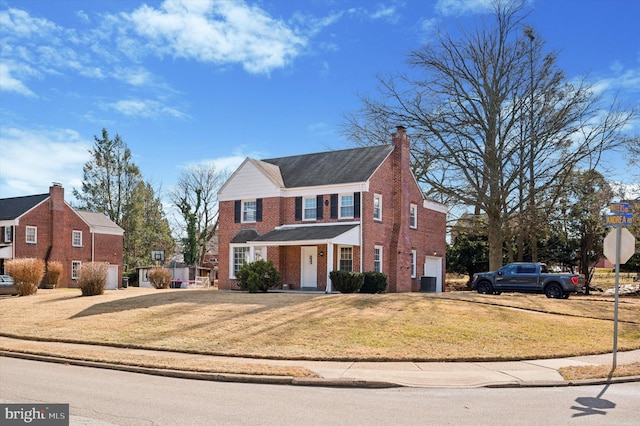 view of front of house with central AC unit, an attached garage, brick siding, a front lawn, and a chimney