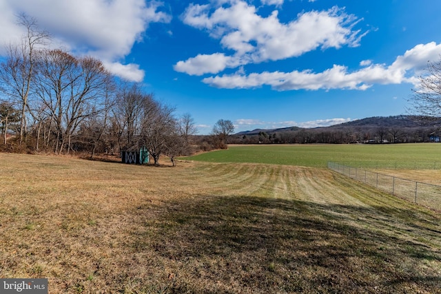 view of yard with a mountain view and a rural view