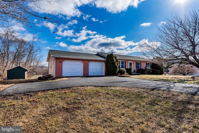 ranch-style home with a garage and a front lawn