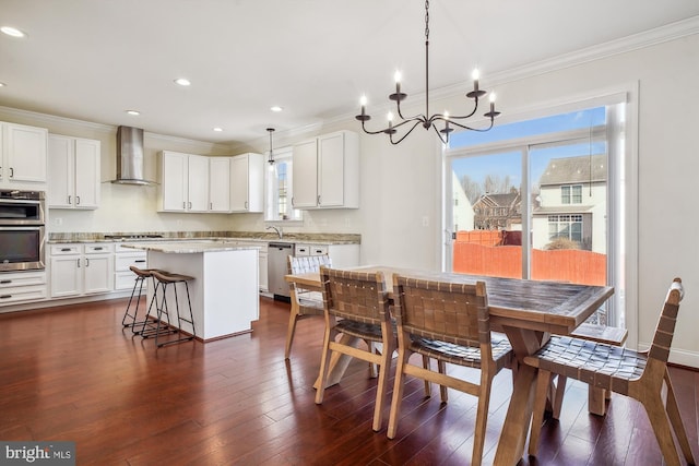 dining space with crown molding and dark hardwood / wood-style flooring