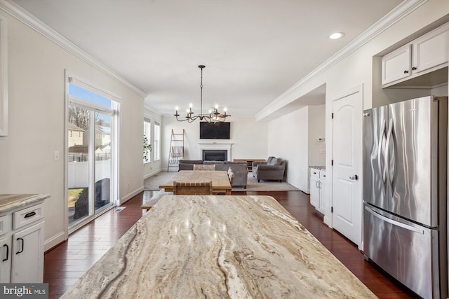 dining space with crown molding, dark wood-type flooring, and a chandelier