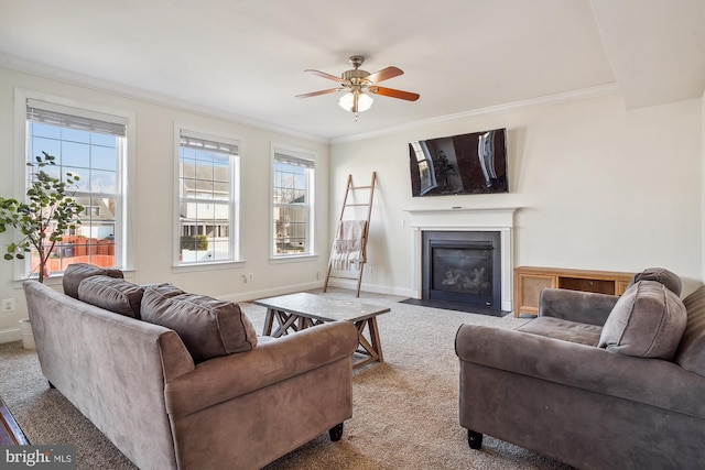 living room featuring crown molding, ceiling fan, and carpet