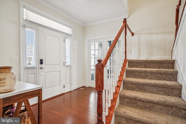 entrance foyer featuring dark hardwood / wood-style flooring and ornamental molding