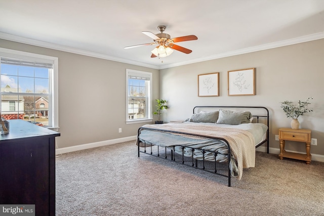 carpeted bedroom with ornamental molding and ceiling fan