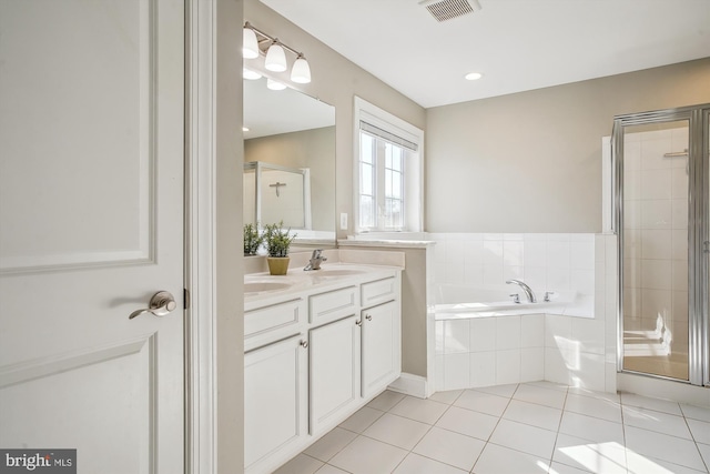 bathroom featuring tile patterned flooring, shower with separate bathtub, and vanity