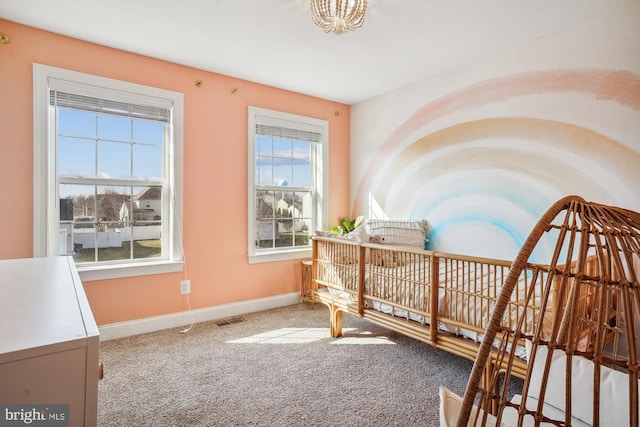 carpeted bedroom with multiple windows