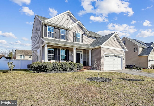 view of front of home featuring cooling unit, a garage, and a front lawn