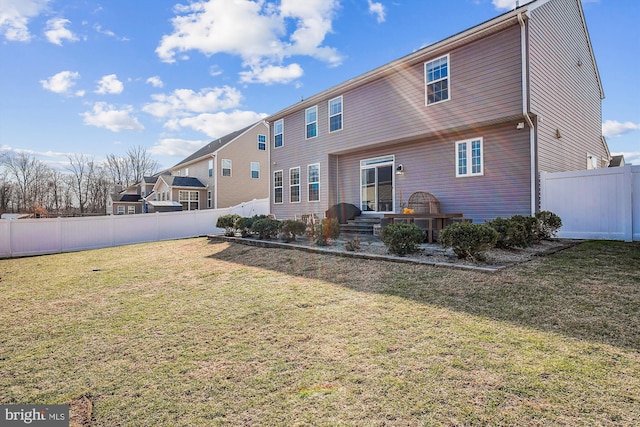 rear view of property featuring a lawn