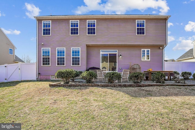 rear view of property with a lawn