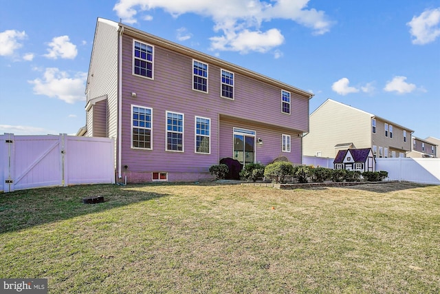 rear view of property featuring a yard