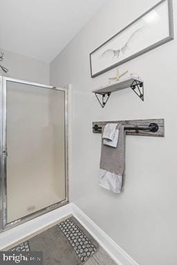 bathroom with a shower with door