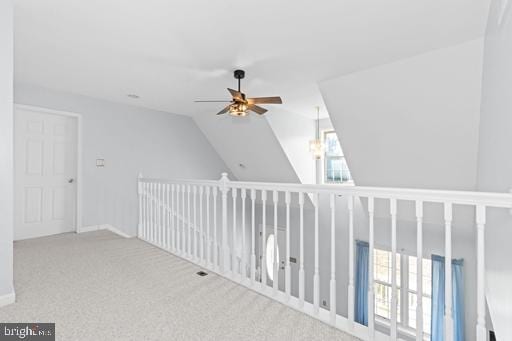 interior space featuring lofted ceiling, light colored carpet, and ceiling fan