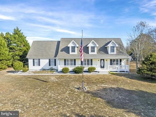 cape cod-style house with a porch and a front yard