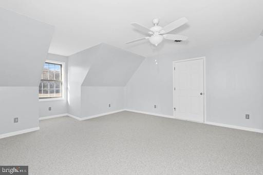 additional living space with lofted ceiling, carpet floors, and ceiling fan