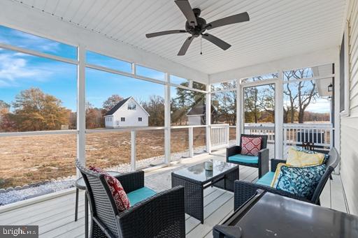 sunroom featuring a wealth of natural light and ceiling fan