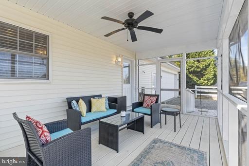 deck featuring an outdoor hangout area and ceiling fan