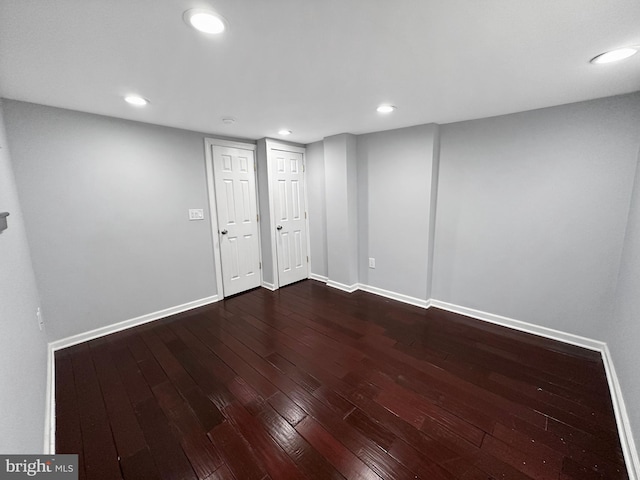 empty room with dark hardwood / wood-style floors