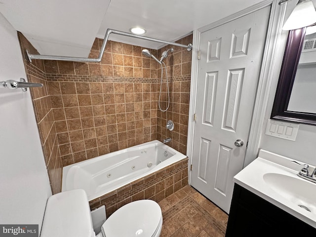 full bathroom featuring vanity, toilet, and tiled shower / bath