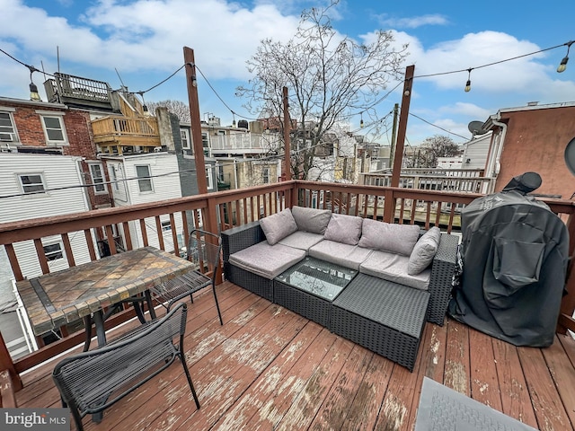 wooden terrace with grilling area and outdoor lounge area