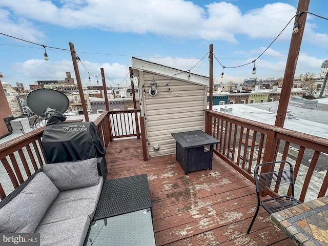 deck with area for grilling and an outdoor fire pit