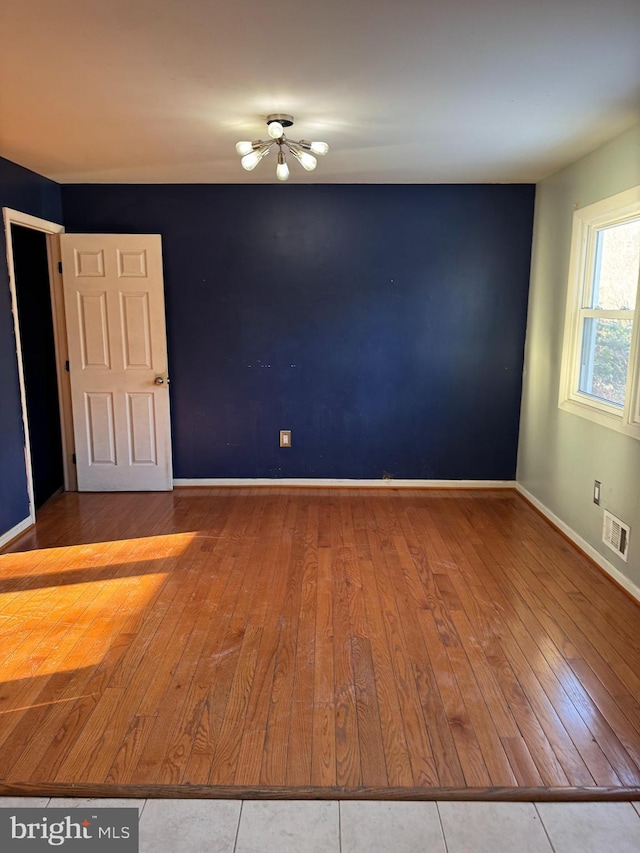 empty room with wood-type flooring