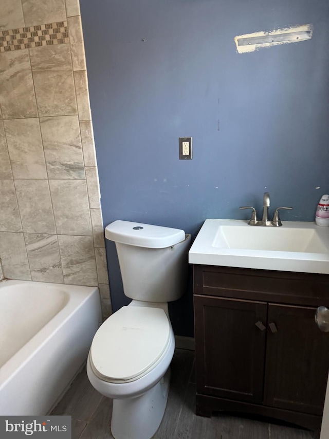 bathroom with vanity, wood-type flooring, and toilet