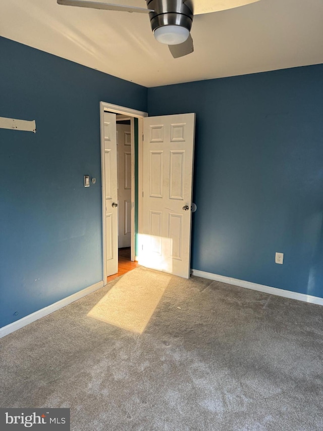 unfurnished bedroom featuring carpet floors and ceiling fan