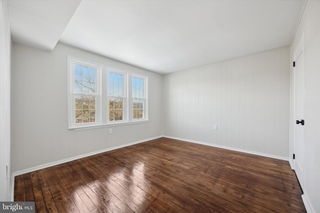 empty room featuring dark hardwood / wood-style flooring