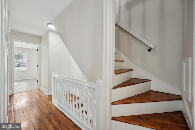 stairs featuring hardwood / wood-style floors