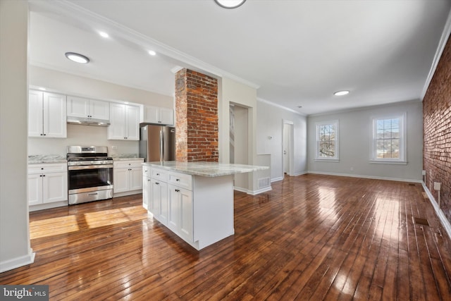 kitchen featuring wood-type flooring, ornamental molding, stainless steel appliances, and white cabinets