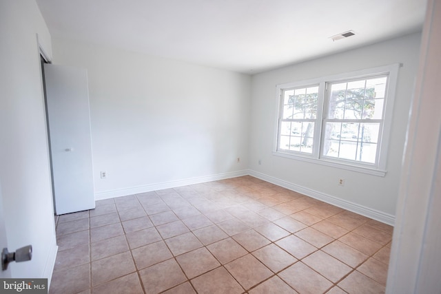 empty room with visible vents and baseboards