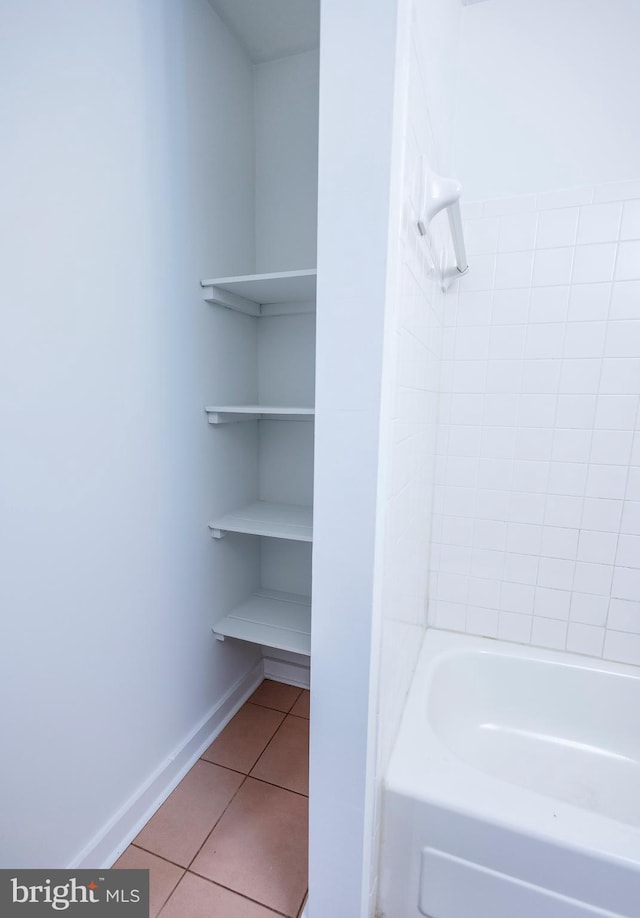 full bathroom featuring tile patterned flooring and baseboards