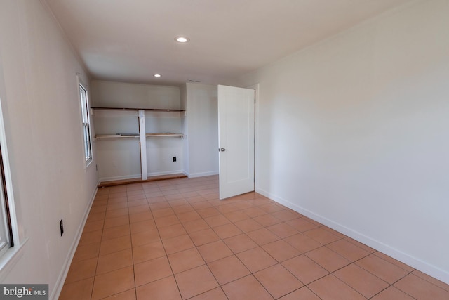 spare room with light tile patterned floors, recessed lighting, and baseboards