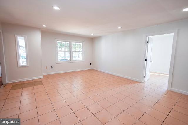 unfurnished room with recessed lighting and baseboards