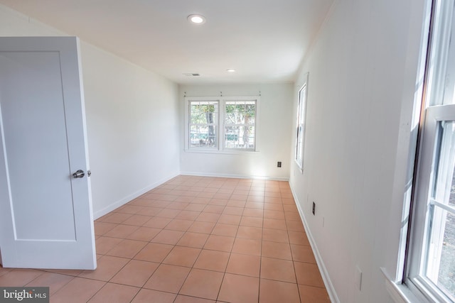 unfurnished room with light tile patterned floors, recessed lighting, and baseboards