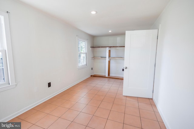 laundry room featuring light tile patterned floors, baseboards, and recessed lighting