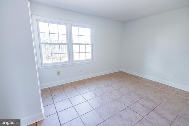 unfurnished room featuring baseboards