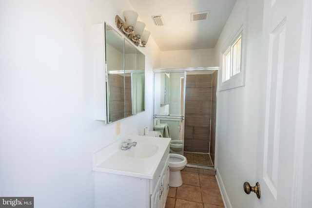 bathroom featuring vanity, a shower stall, toilet, and visible vents