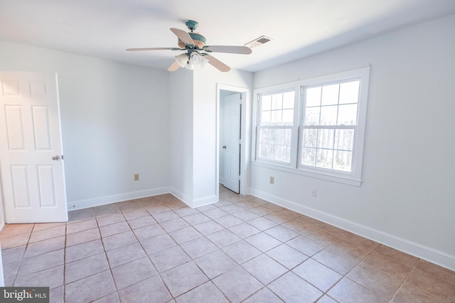 unfurnished bedroom with a ceiling fan, light tile patterned floors, baseboards, and visible vents