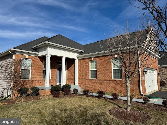 view of front of house featuring a garage and a front lawn