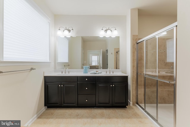 bathroom featuring vanity, tile patterned flooring, and a shower with door