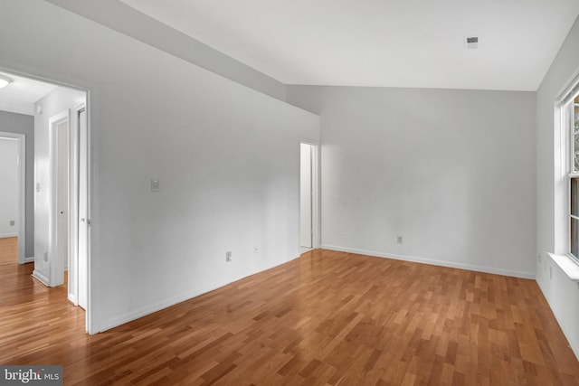 unfurnished room featuring baseboards and wood finished floors